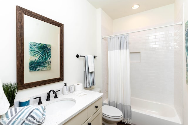 full bathroom featuring shower / bath combination with curtain, vanity, and toilet