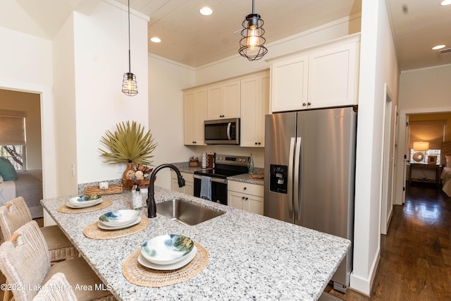 kitchen with light stone countertops, dark hardwood / wood-style flooring, stainless steel appliances, sink, and hanging light fixtures