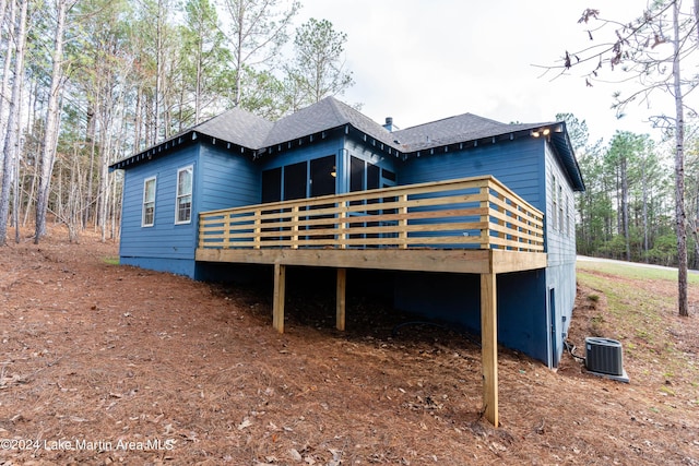 rear view of property with central AC and a deck