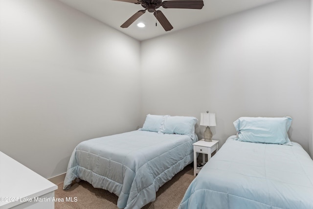 bedroom featuring ceiling fan and carpet