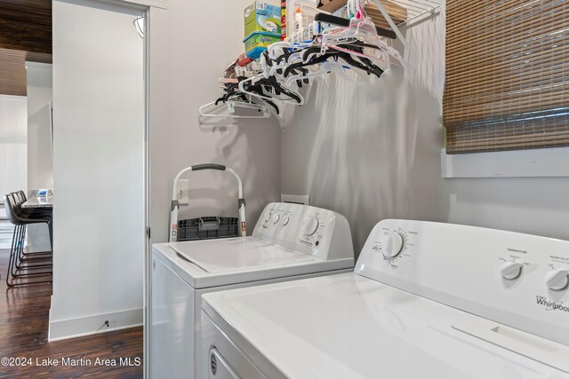 laundry area with dark wood-type flooring and washing machine and clothes dryer