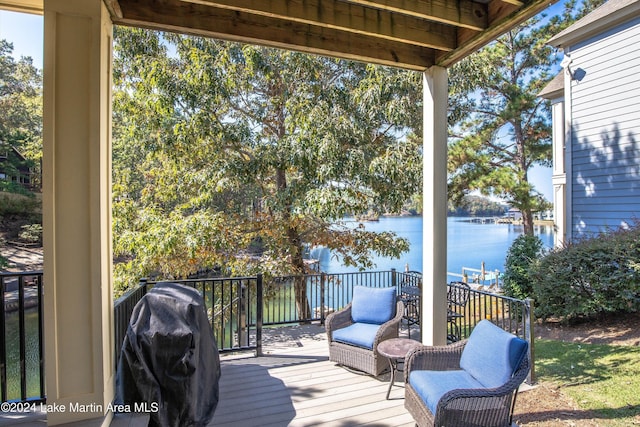 wooden deck featuring a water view and grilling area