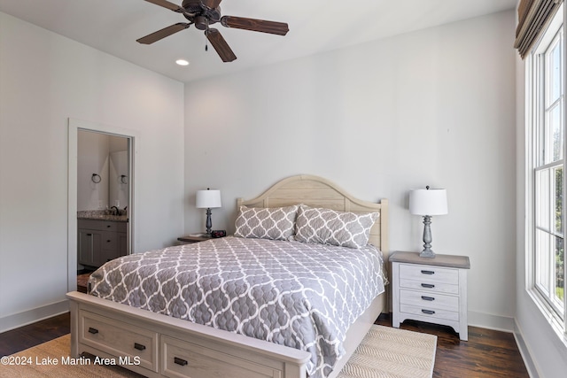 bedroom with ensuite bathroom, dark hardwood / wood-style floors, and ceiling fan