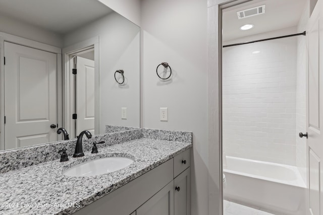 bathroom featuring vanity and shower / tub combination