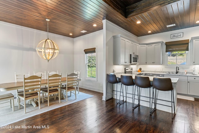 kitchen featuring wood ceiling, a wealth of natural light, stainless steel appliances, and decorative light fixtures