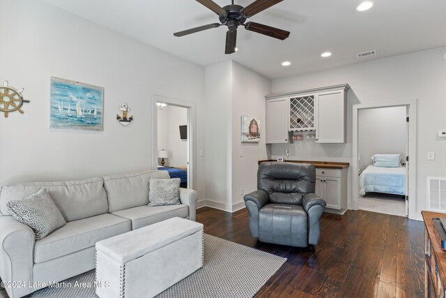 living room with dark hardwood / wood-style floors and ceiling fan