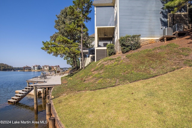 view of dock featuring a yard and a water view