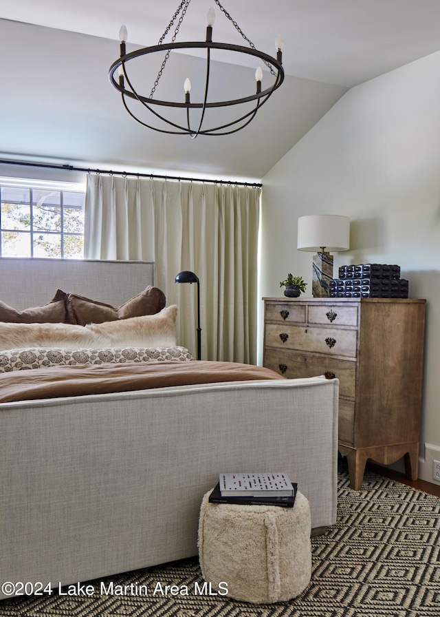 bedroom with vaulted ceiling and an inviting chandelier