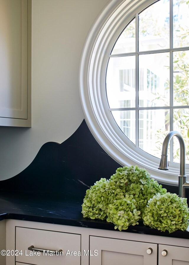 bar with white cabinetry, ornamental molding, plenty of natural light, and sink