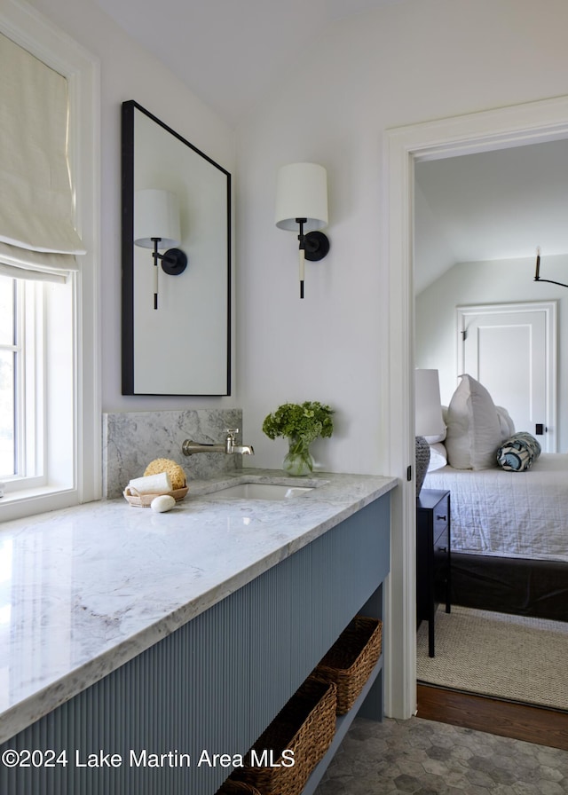 interior space featuring lofted ceiling and sink