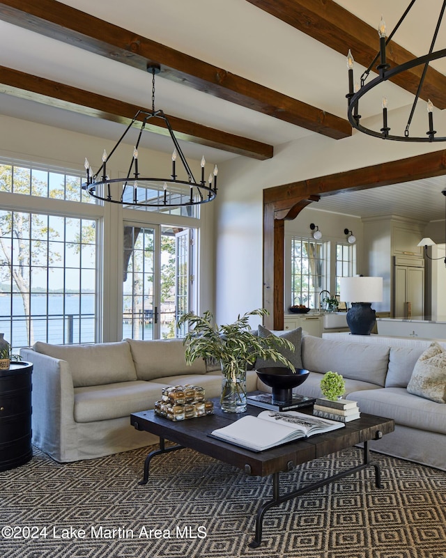 living room with beamed ceiling, an inviting chandelier, and french doors