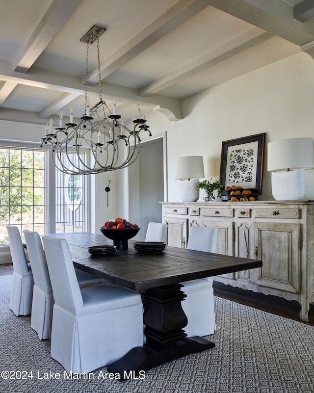 carpeted dining space featuring beamed ceiling