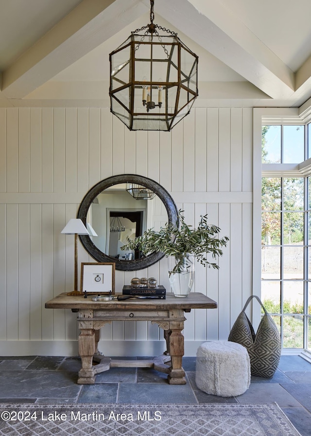 room details featuring a notable chandelier and wooden walls