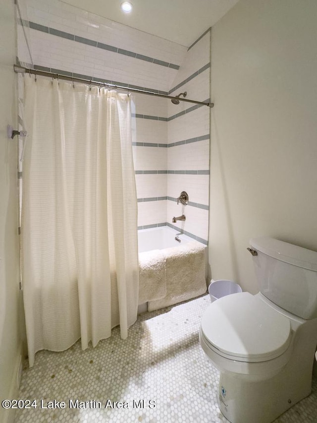 bathroom with toilet, tile patterned flooring, and shower / tub combo