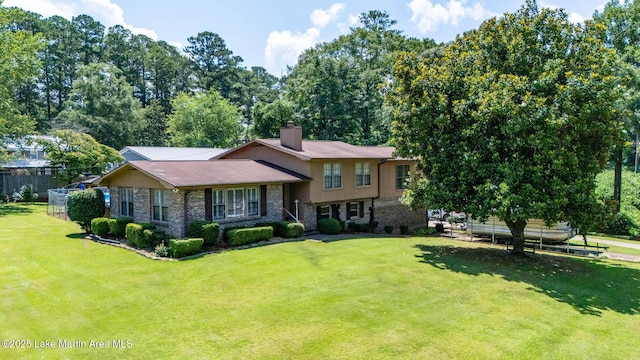 207 Mcdonald St, Dadeville, AL 36853 - tri-level home with a chimney and stone siding