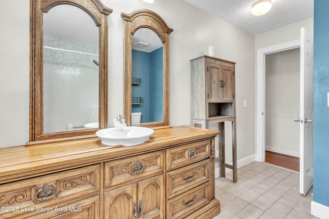 207 Mcdonald St, Dadeville, AL 36853 - full bathroom with vanity, tile patterned floors, a shower, and a textured ceiling