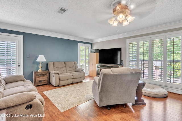 207 Mcdonald St, Dadeville, AL 36853 - living area featuring ceiling fan, wood finished floors, a textured ceiling, and crown molding