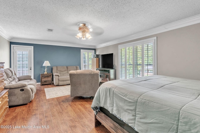 207 Mcdonald St, Dadeville, AL 36853 - bedroom with wood finished floors, crown molding, a textured ceiling, and ceiling fan