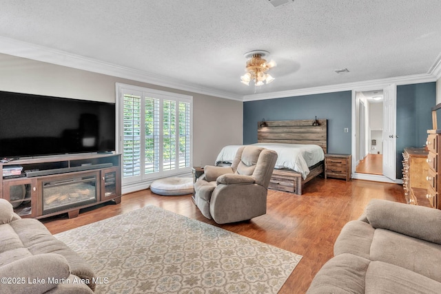 207 Mcdonald St, Dadeville, AL 36853 - bedroom with crown molding, wood finished floors, and a textured ceiling