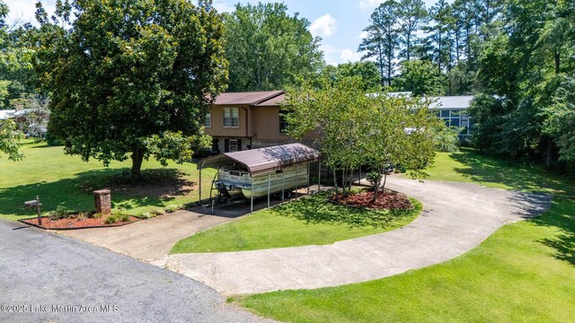 207 Mcdonald St, Dadeville, AL 36853 - view of front of home featuring driveway, a carport, and a front yard