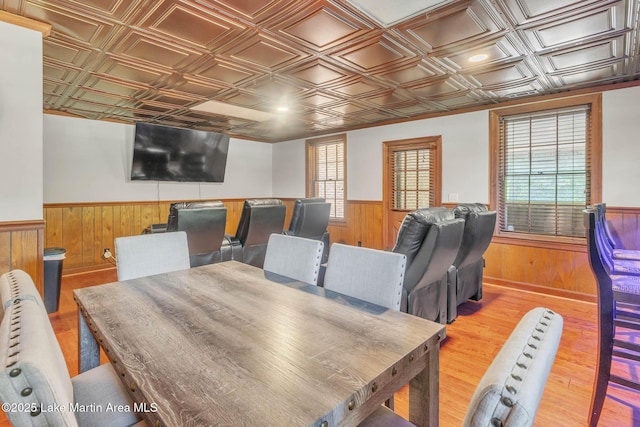 207 Mcdonald St, Dadeville, AL 36853 - dining space with a wainscoted wall, wooden walls, an ornate ceiling, wood finished floors, and plenty of natural light