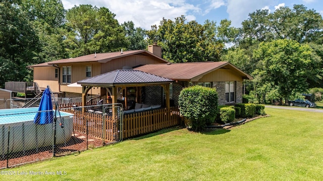 207 Mcdonald St, Dadeville, AL 36853 - rear view of house featuring a gazebo, a chimney, and view of wooded area
