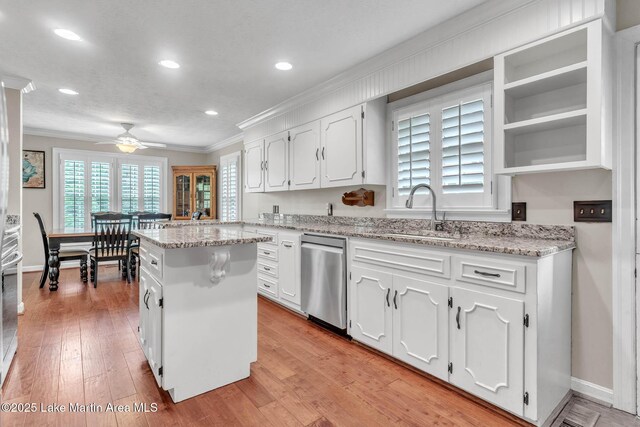 207 Mcdonald St, Dadeville, AL 36853 - kitchen with dishwasher, ornamental molding, white cabinetry, a center island, and recessed lighting