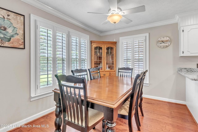 207 Mcdonald St, Dadeville, AL 36853 - dining area with light wood finished floors, crown molding, and ceiling fan