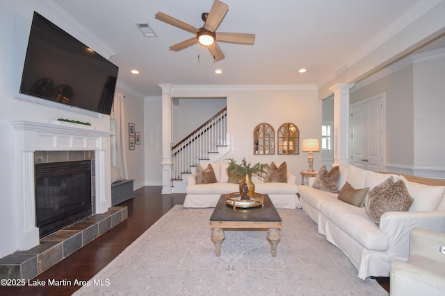 1520 Club Creek Dr, Auburn, AL 36830 - living area with visible vents, a fireplace, wood finished floors, stairway, and a ceiling fan