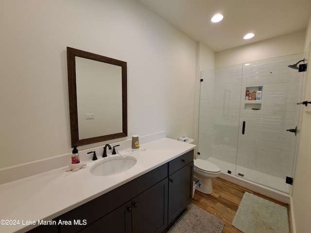108 Williamson Trce, Tallassee, AL 36078 - bathroom with hardwood / wood-style floors, vanity, toilet, and an enclosed shower