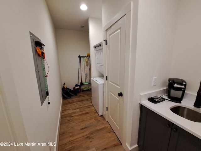 108 Williamson Trce, Tallassee, AL 36078 - corridor with stacked washer and dryer, light hardwood / wood-style floors, and sink