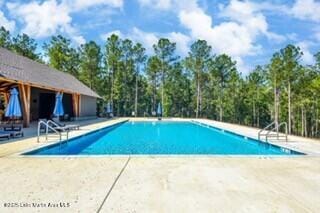 community pool with a patio area