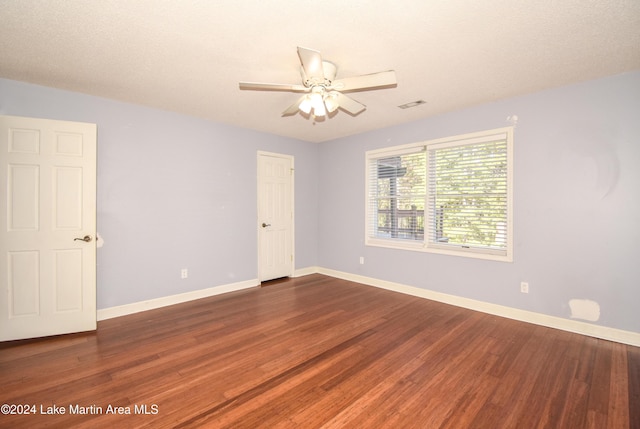 unfurnished room with wood-type flooring, a textured ceiling, and ceiling fan