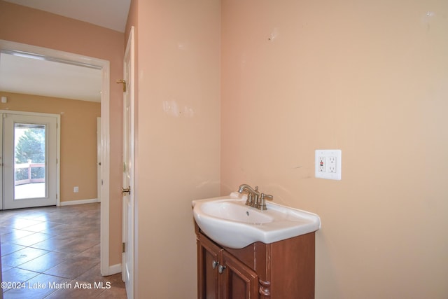 bathroom with tile patterned flooring, vanity, and french doors