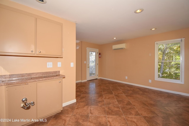 kitchen featuring tile patterned flooring and a wall mounted air conditioner