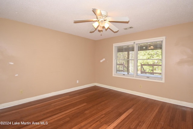 spare room featuring hardwood / wood-style floors, a textured ceiling, and ceiling fan