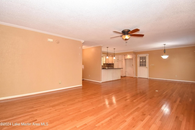 unfurnished living room featuring ornamental molding, a textured ceiling, and light hardwood / wood-style flooring