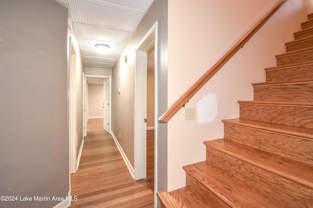 hallway with wood-type flooring