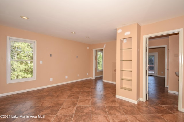 spare room featuring tile patterned floors and a healthy amount of sunlight