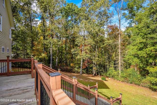 wooden deck featuring a lawn