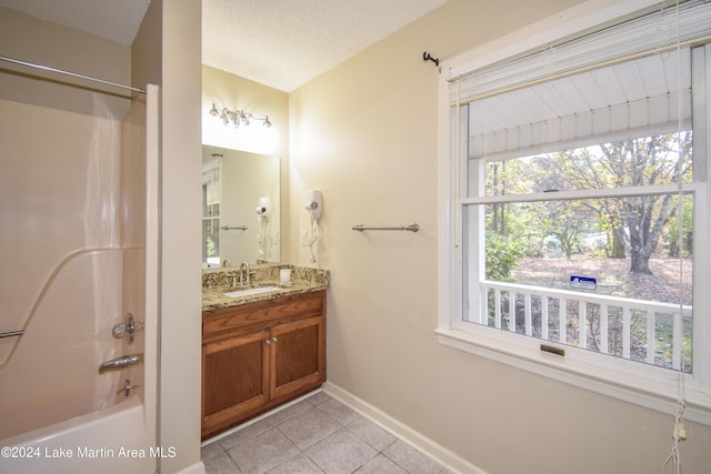 bathroom featuring tile patterned floors, vanity, shower / bathtub combination, and a textured ceiling