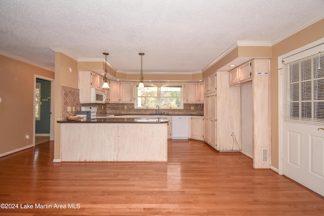 kitchen with white appliances, sink, and light hardwood / wood-style flooring