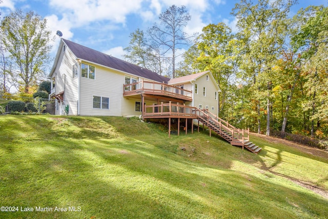 back of property with a lawn and a wooden deck