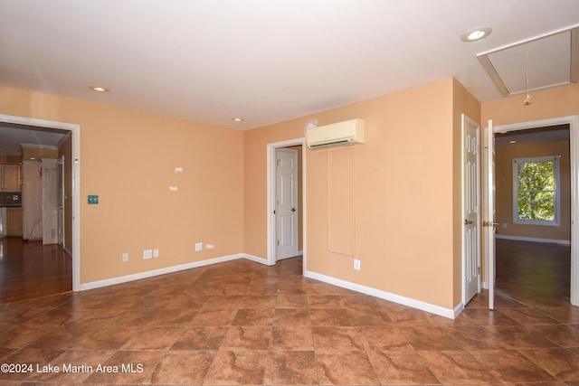 unfurnished room featuring a wall mounted AC