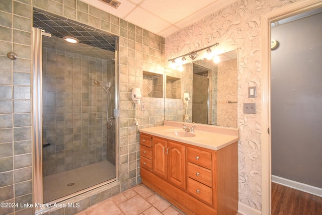 bathroom with vanity, a shower with shower door, and hardwood / wood-style flooring