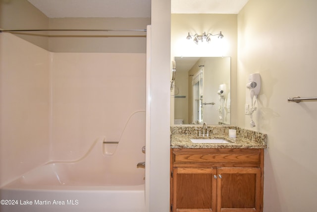 bathroom with vanity and shower / washtub combination