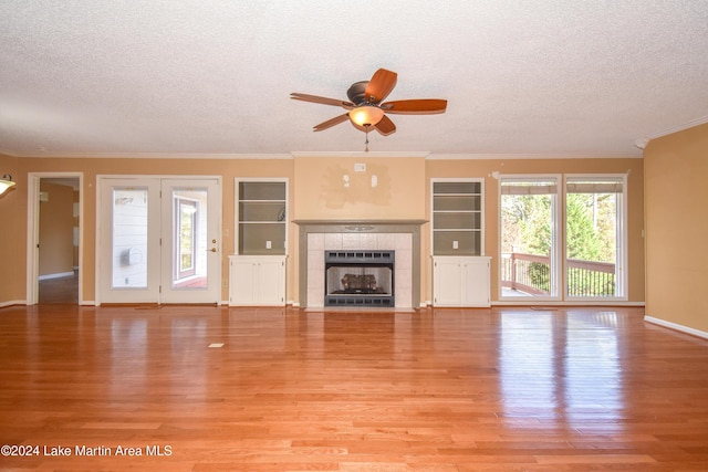 unfurnished living room featuring a textured ceiling and light wood-type flooring