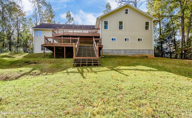 back of house with a lawn and a deck