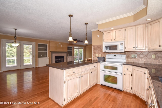 kitchen with kitchen peninsula, white appliances, light hardwood / wood-style flooring, and plenty of natural light