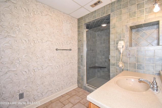 bathroom with vanity and a shower with shower door